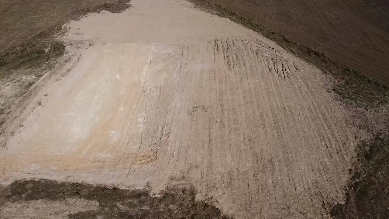 Aerial of a large sandy pad graded smooth